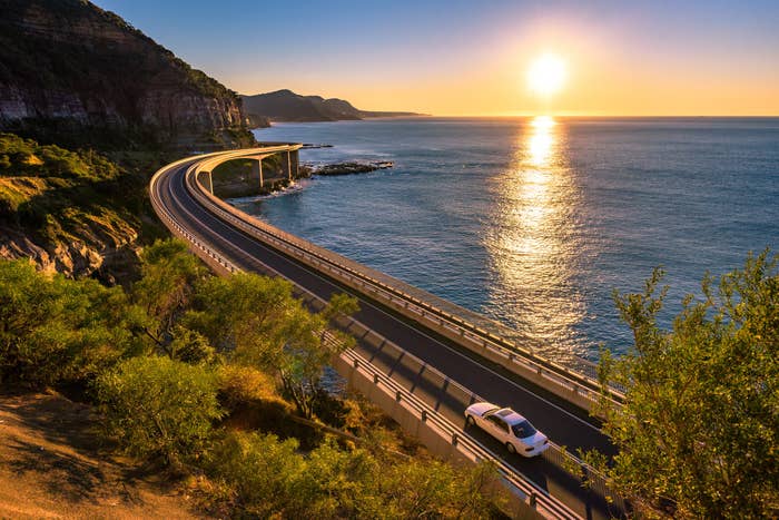 A car driving next to the ocean