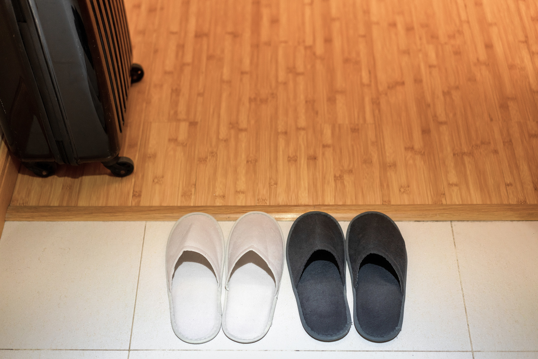 Two pairs of slippers in a hallway