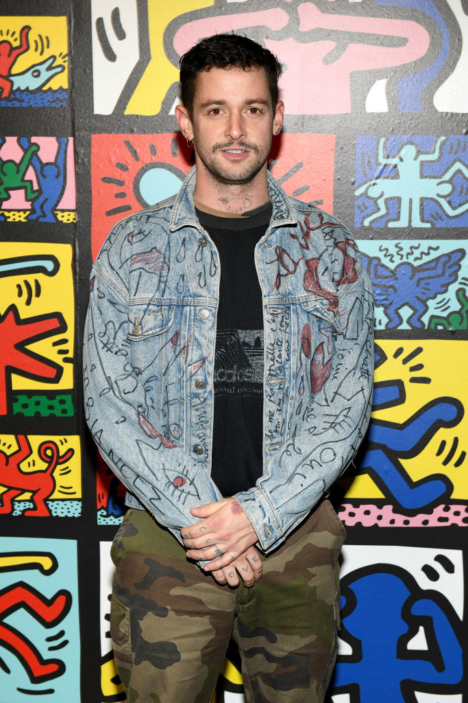 Charlie Le Mindu wearing a jean jacket with drawings all over it and some cameo pants