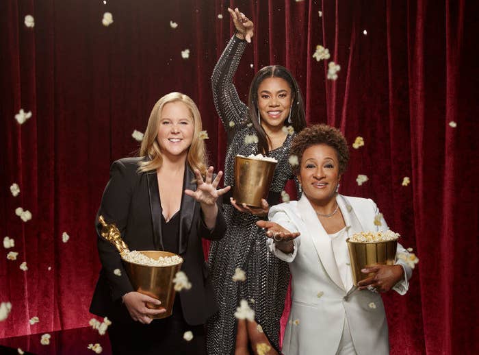 Amy, Regina, and Wanda throwing popcorn in a promo photo for the Oscars