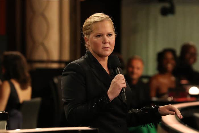 Amy Schumer looks serious with a mic in her hand