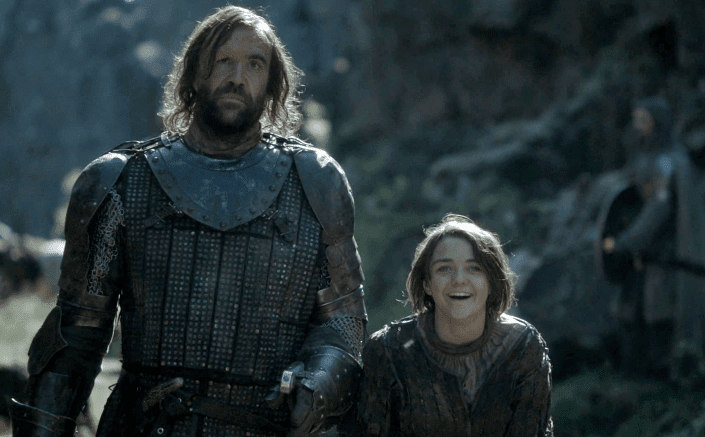Rory McCann as the Hound and Maisie Williams as Arya Stark walking together