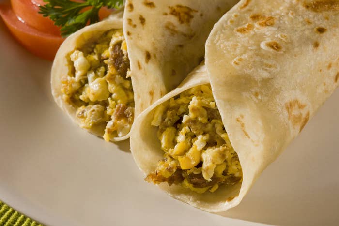 Scrambled eggs with machaca dried meat tacos in flour tortillas.