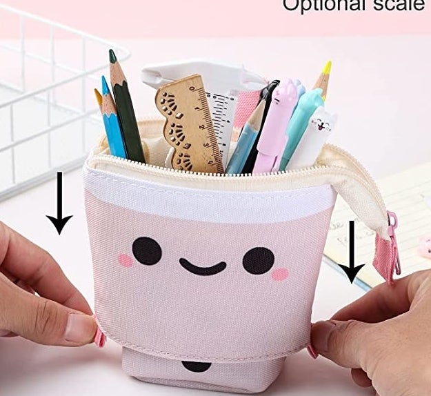 A person pulling the case down to make it into a pencil cup