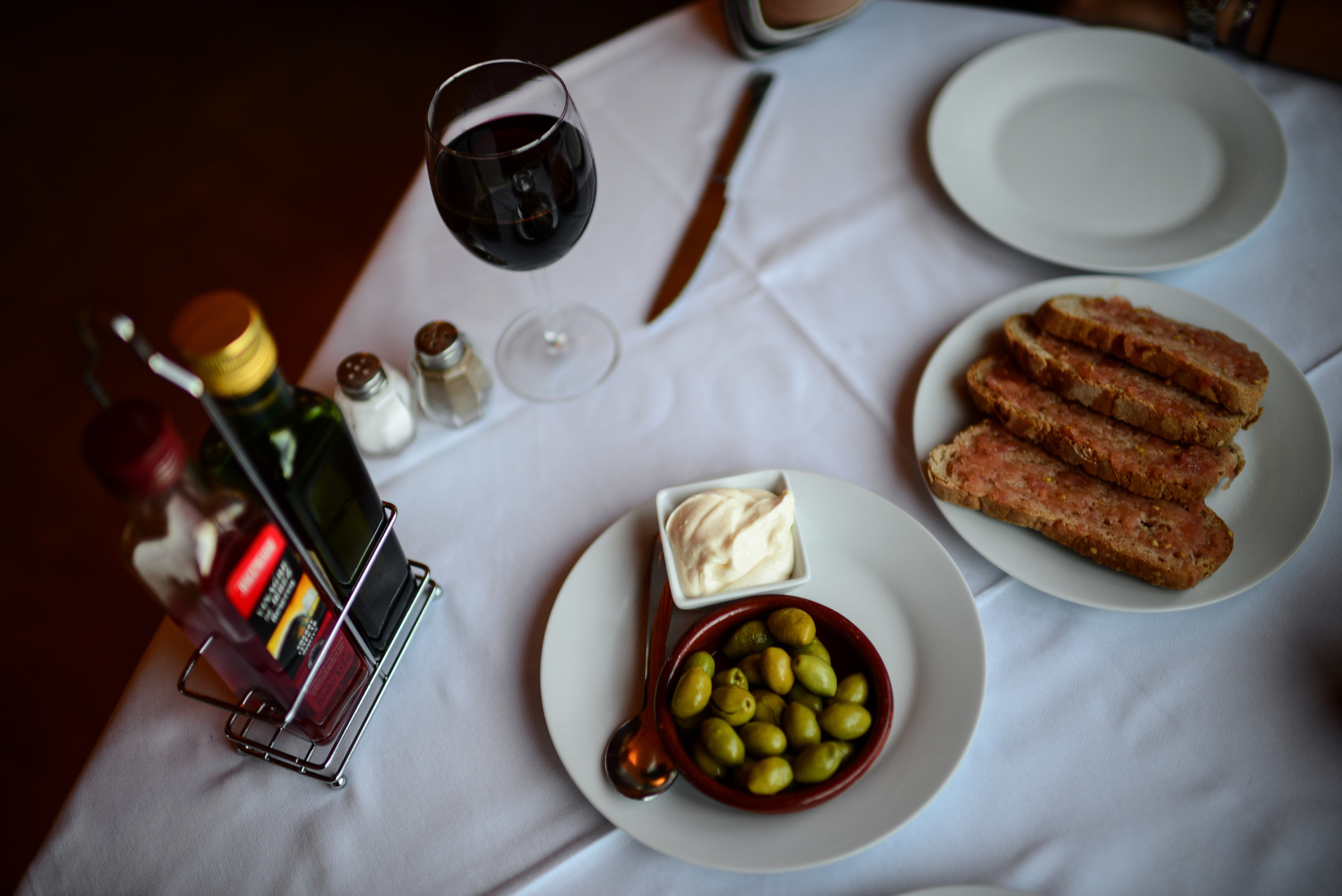 Olives, butter, and bread on a table