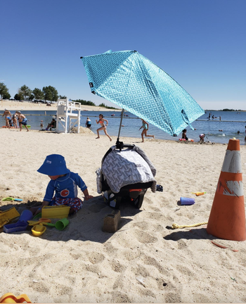 Reviewer who attached the umbrella to a car seat on the beach to shade a child