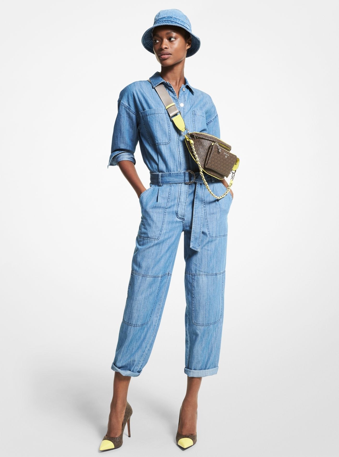 a person wearing the full-length belted chambray jumpsuit
