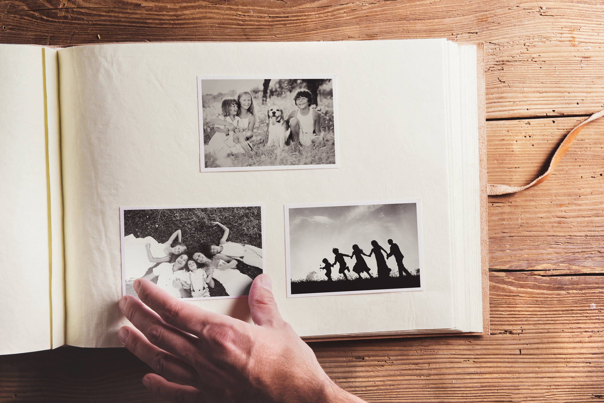A hand resting on a photo album