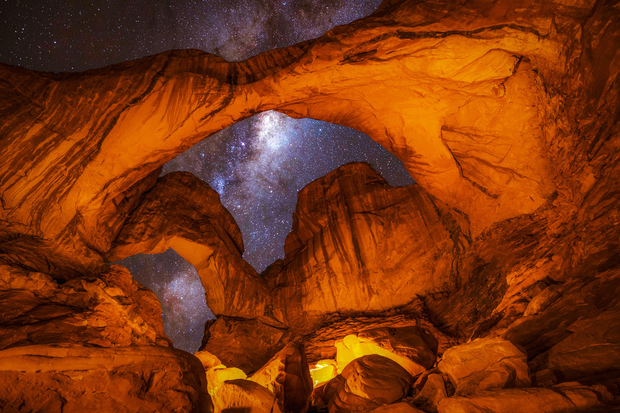 a big rock in front of the night sky