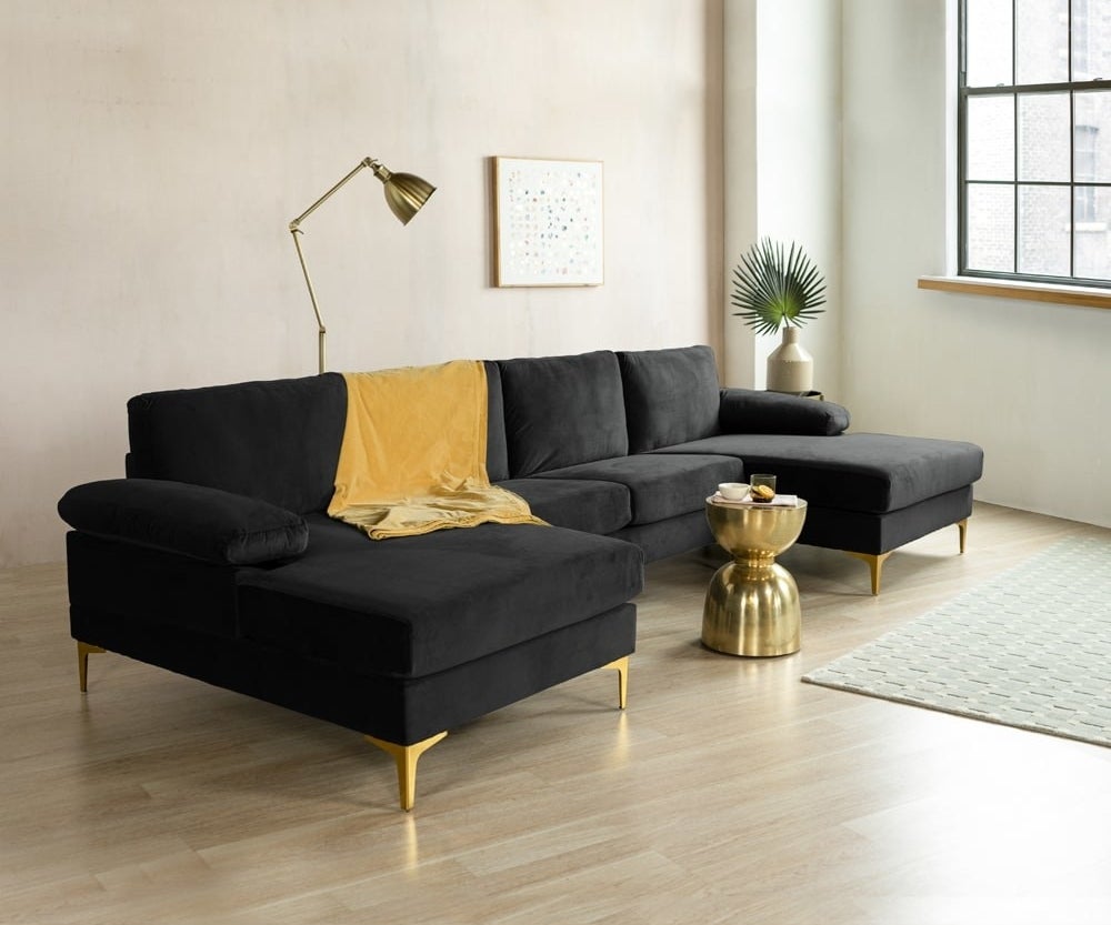 the black xl sectional with gold legs