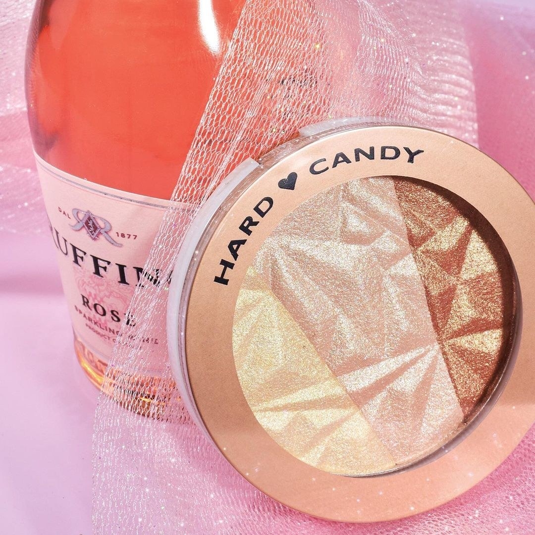 the rose gold highlighter next to a bottle of rosé