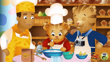 Animated characters including two anthropomorphic tigers, cooking baking in a kitchen