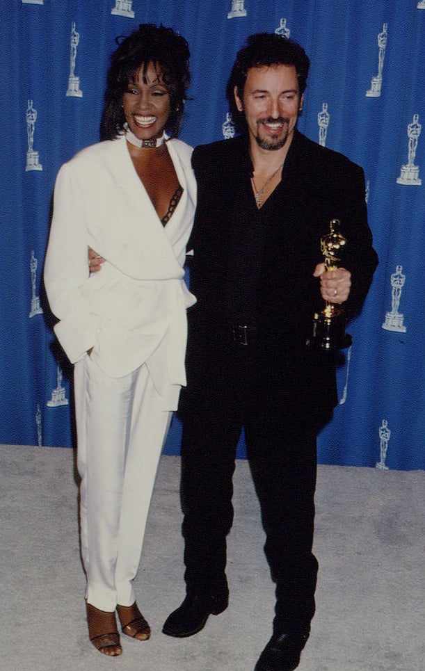 Whitney wearing a white pant suit