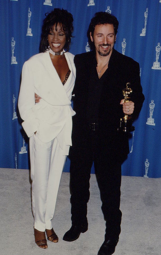 Whitney wearing a white pant suit