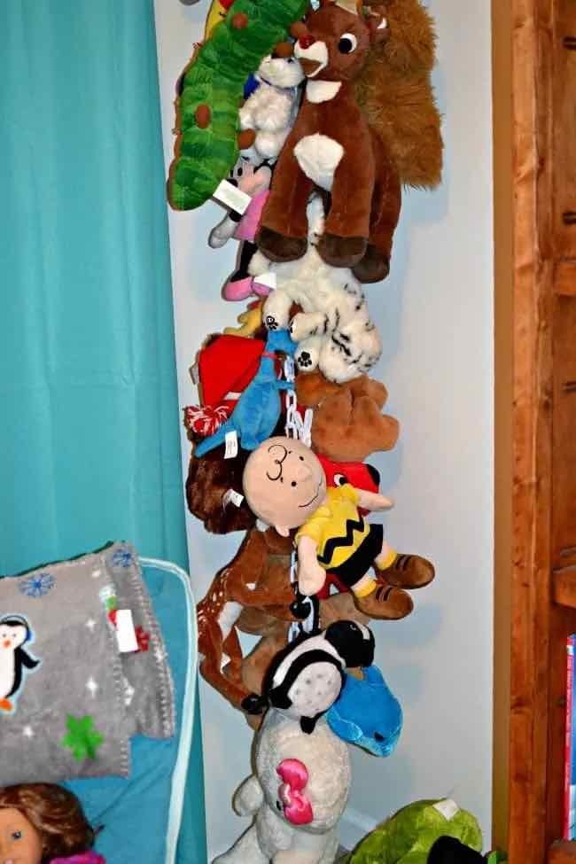 Blogger&#x27;s photo of their child&#x27;s stuffed animals hanging on a chain in a room