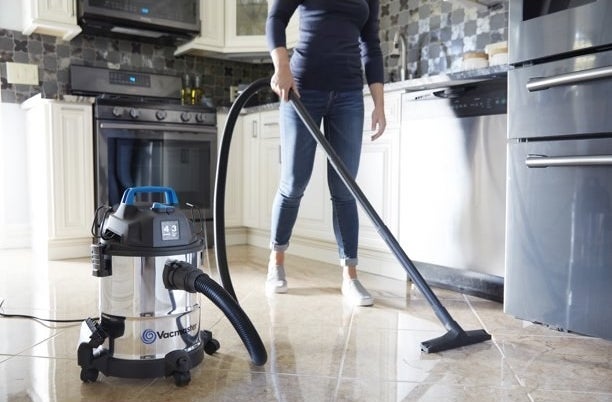 model using the stainless steel vacuum in a kitchen