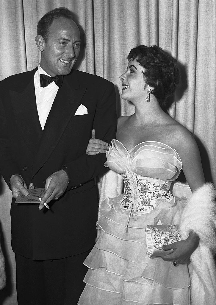 Elizabeth Taylor in a white corset and tulle gown with fur
