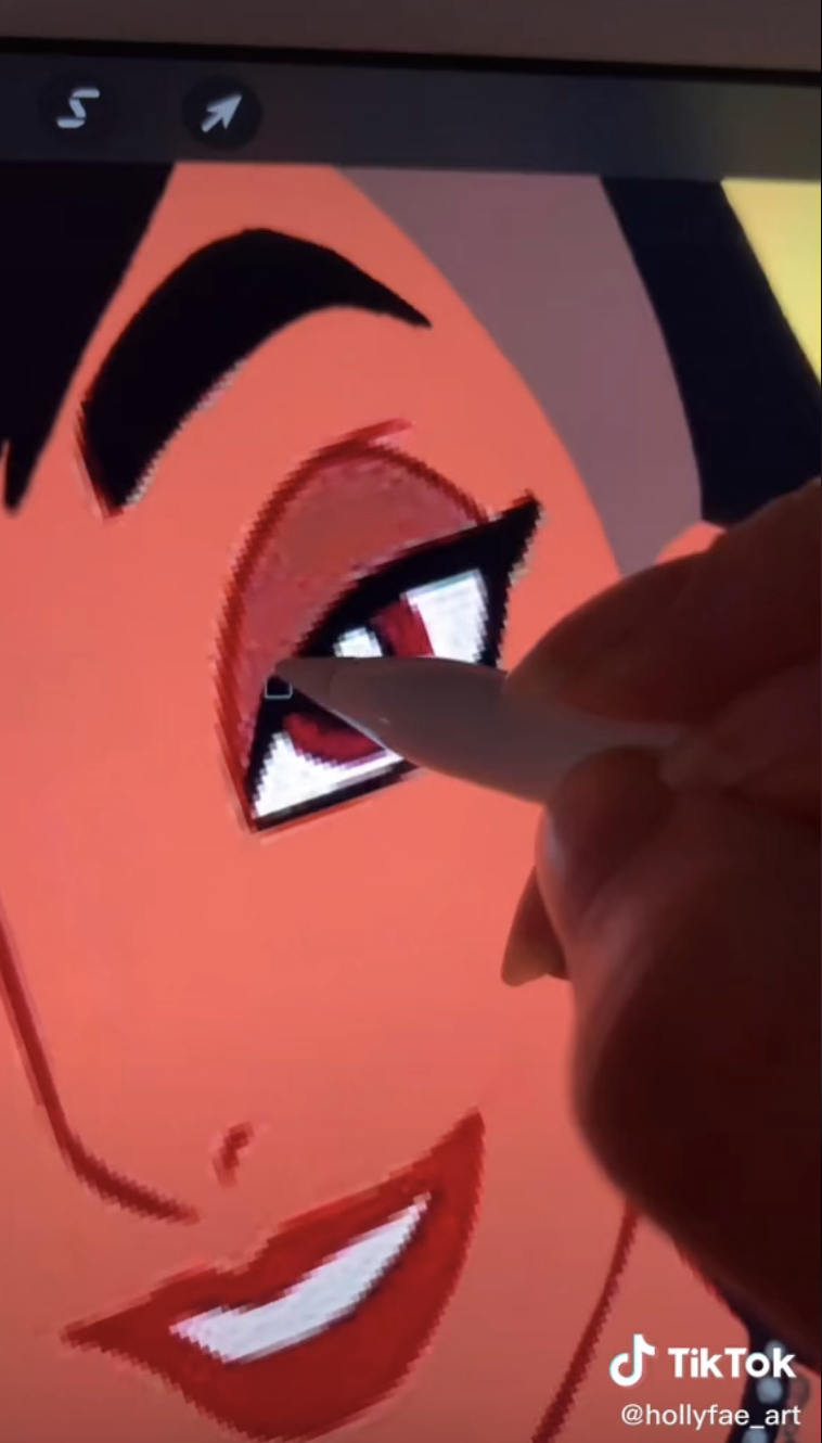 The artist giving Jasmine heavier eye makeup using the stylus