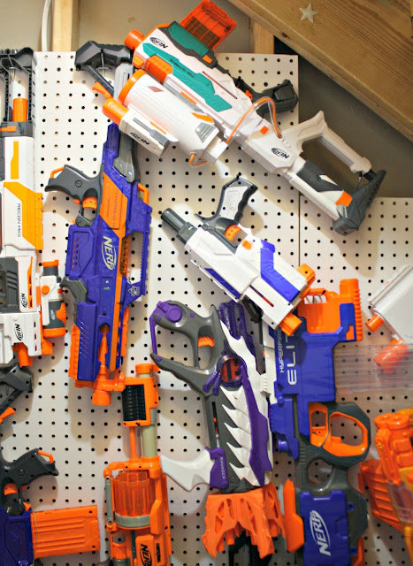 Blogger&#x27;s photo of nerf guns hanging from a pegboard wall