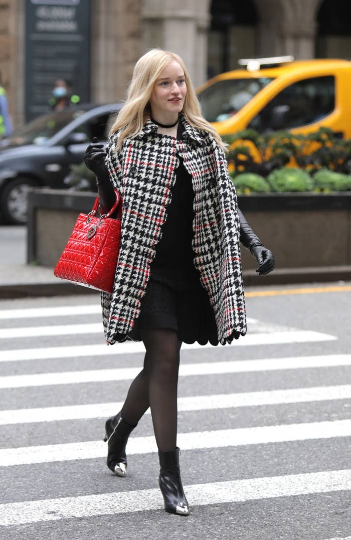 Julia Garner walks down street as Anna Delvey