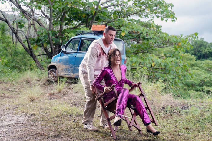 Channing Tatum handles a wooden chair on which Sandra Bullock is sitting