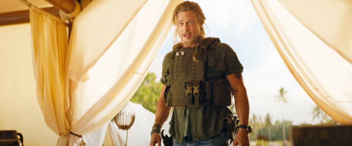Brad Pitt stands in a camp