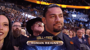 Roman Reigns nods and stares at the camera