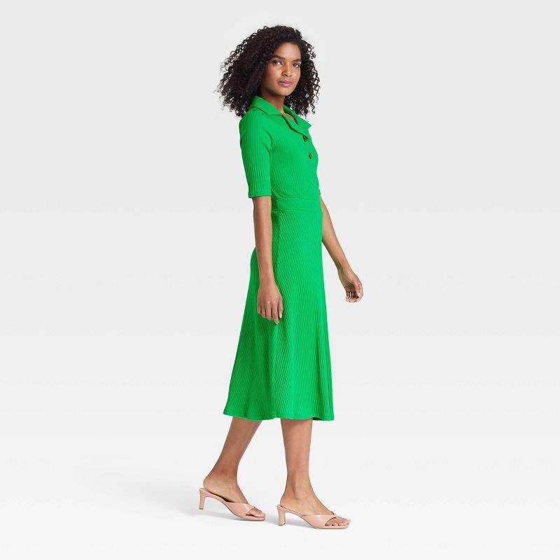 Model wearing the bright green elbow-length dress