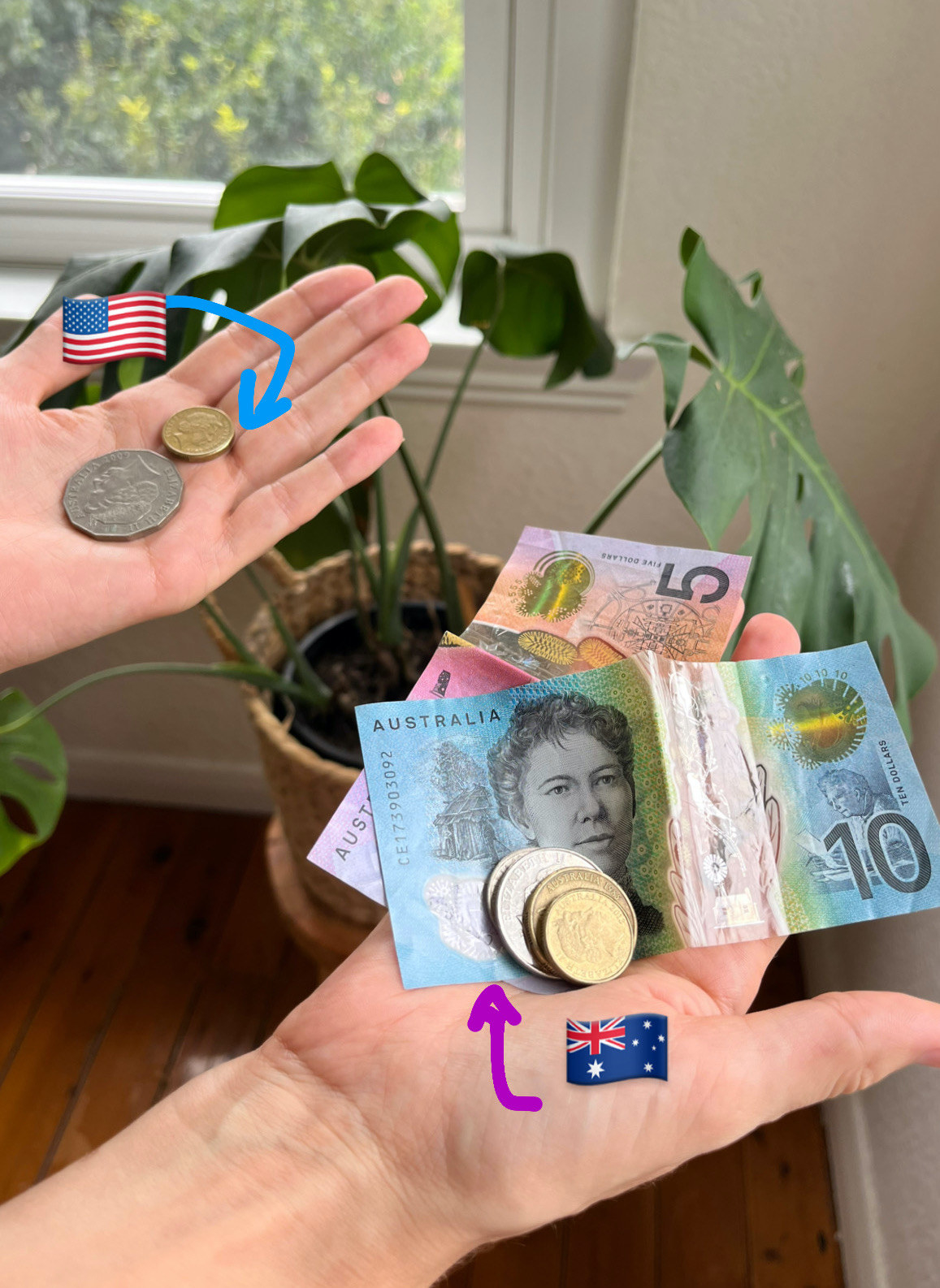 One hand holding American money, one holding Australian money