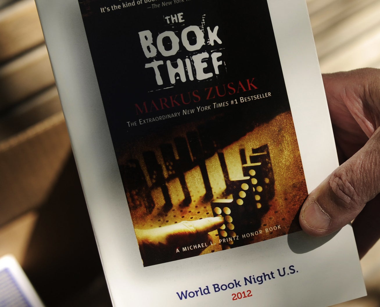A man hands out free copies of The Book Thief as part of World Book Night