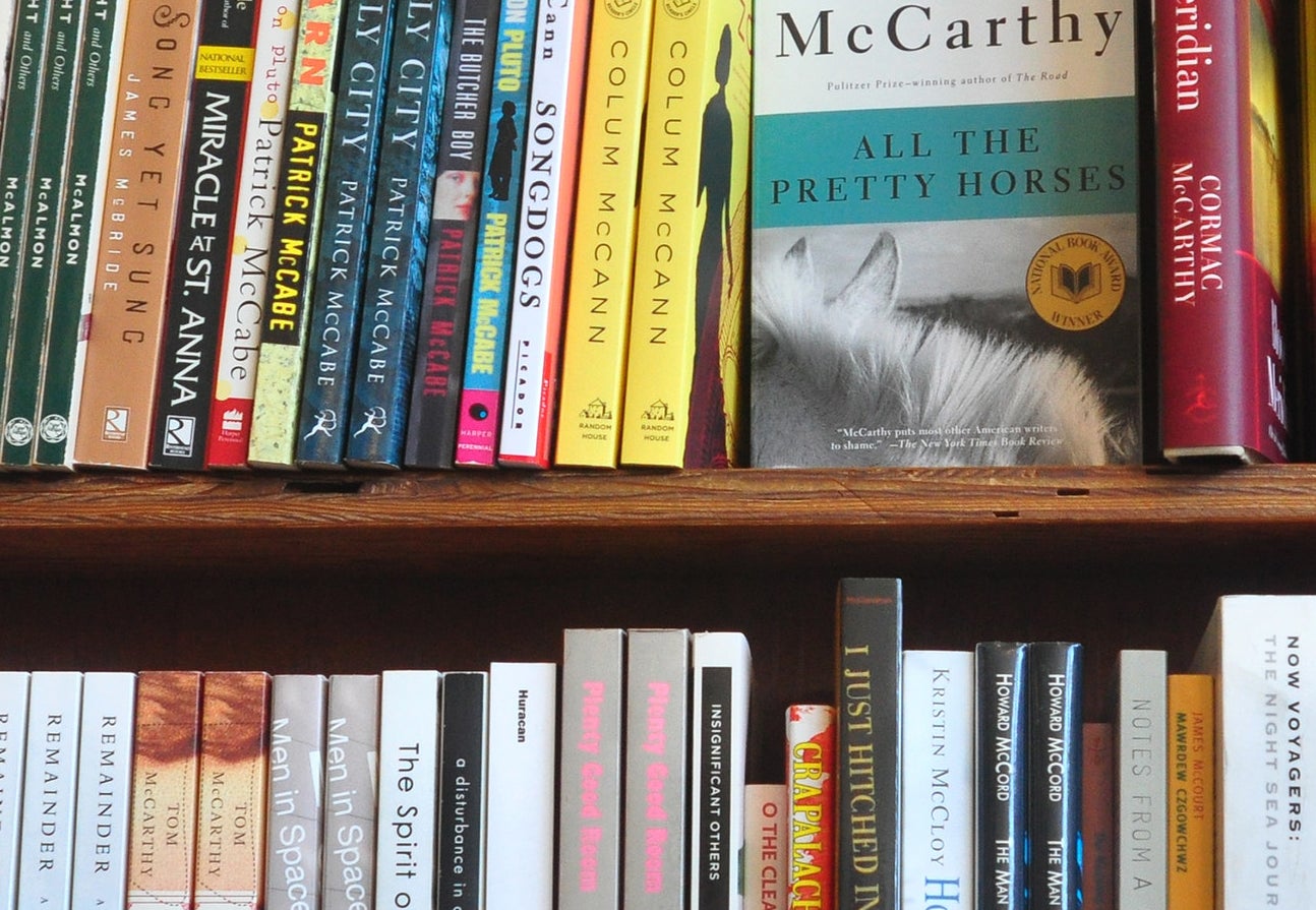 A copy of All the Pretty Horses on a shelf in a bookstore