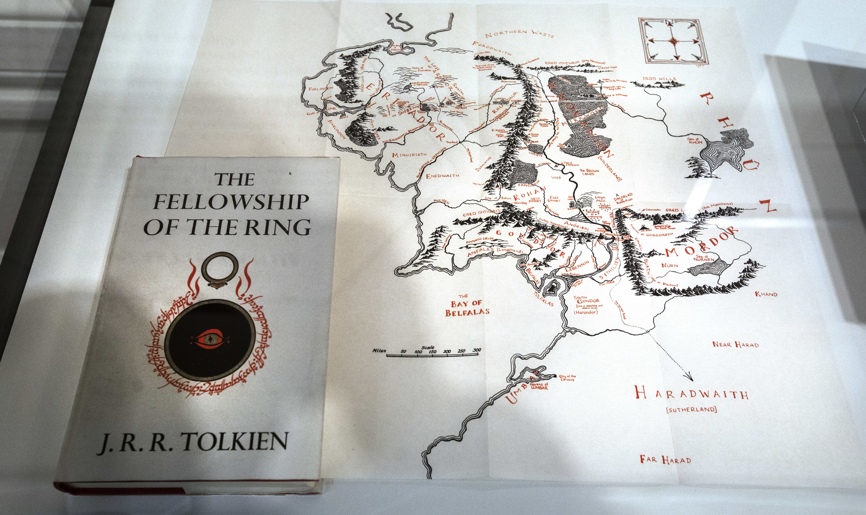 A copy of The Fellowship of the Ring sitting on a map of Middle Earth