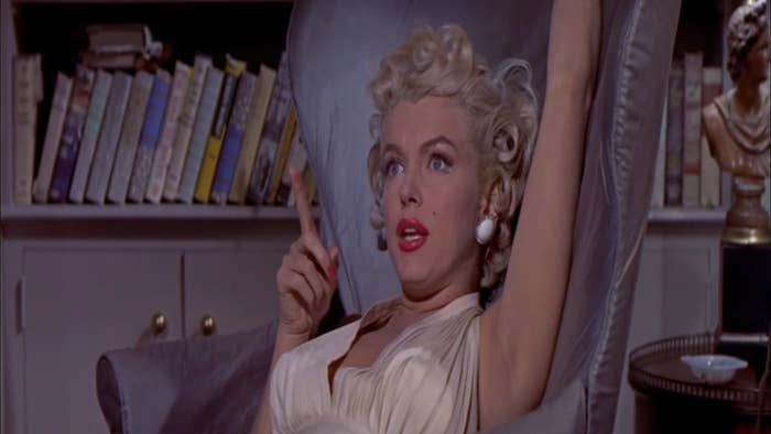 Marilyn Monroe leans back in an armchair and talks