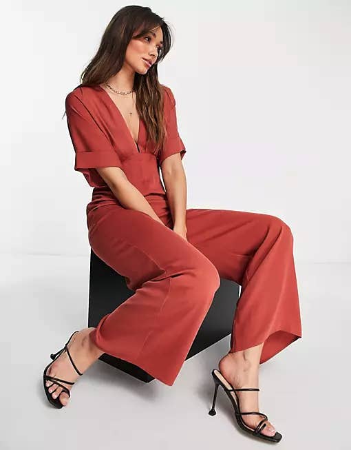 a model wearing the red jumpsuit, showing the eep v neckline