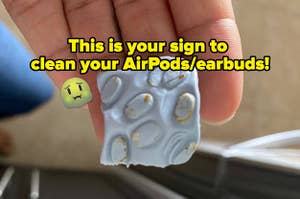 Blue cleaning putty square with chunks of earwax on it from someone's AirPods and text on the image that says "this is your sign to clean your AirPods/earbuds"