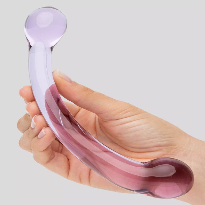 Model holding pink dual-ended dildo