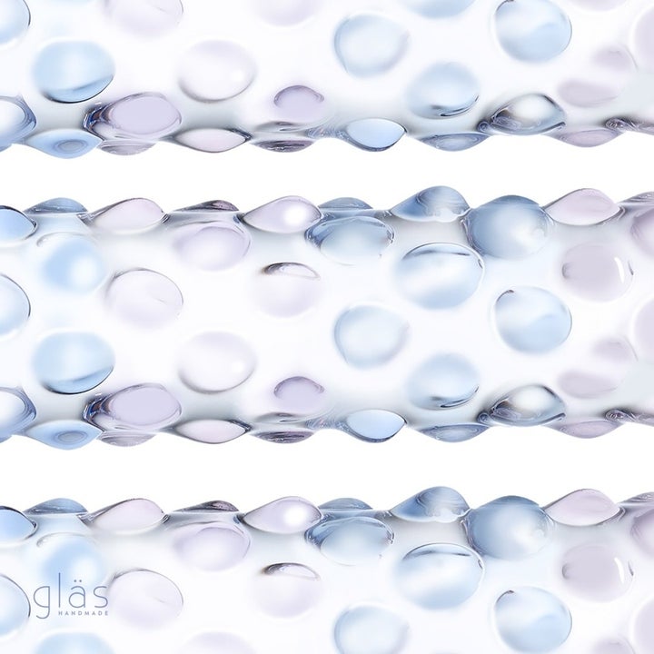 Close-up of glass dildo with purple and blue nubs