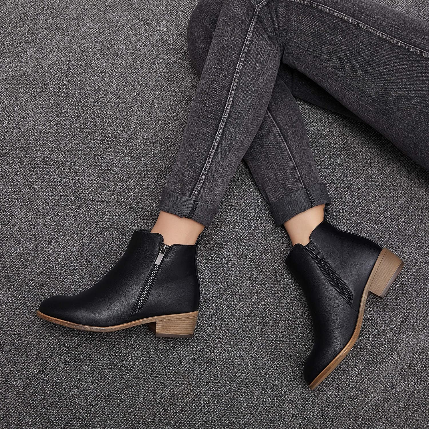 model wears black ankle boots with zipper on the side