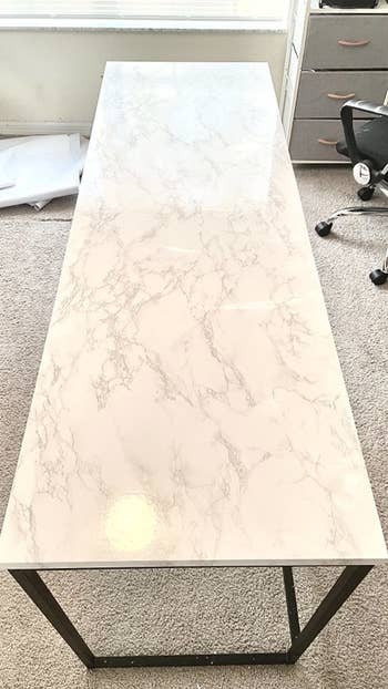 Reviewer photo of the same table with marble contact paper on the surface