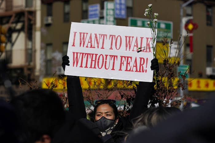 A women&#x27;s sign says &quot;I want to walk without fear&quot;