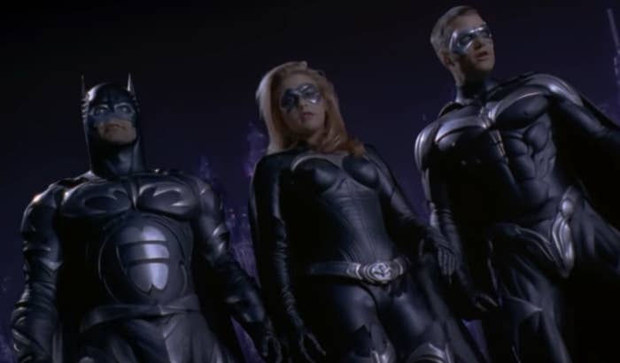 George Clooney as Batman Alicia Silverstone as Batgirl and Chris Odonnell as Robin standing in their costumes together