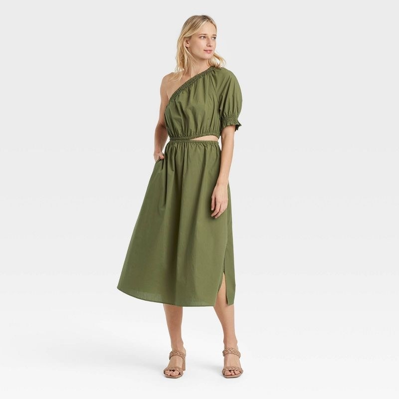 model wearing army green dress with small slit, side pockets