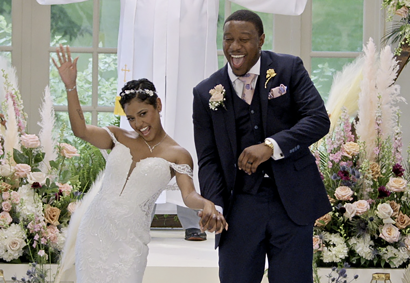 The couple are excited while walking down the aisle after their &quot;I do&#x27;s&quot;