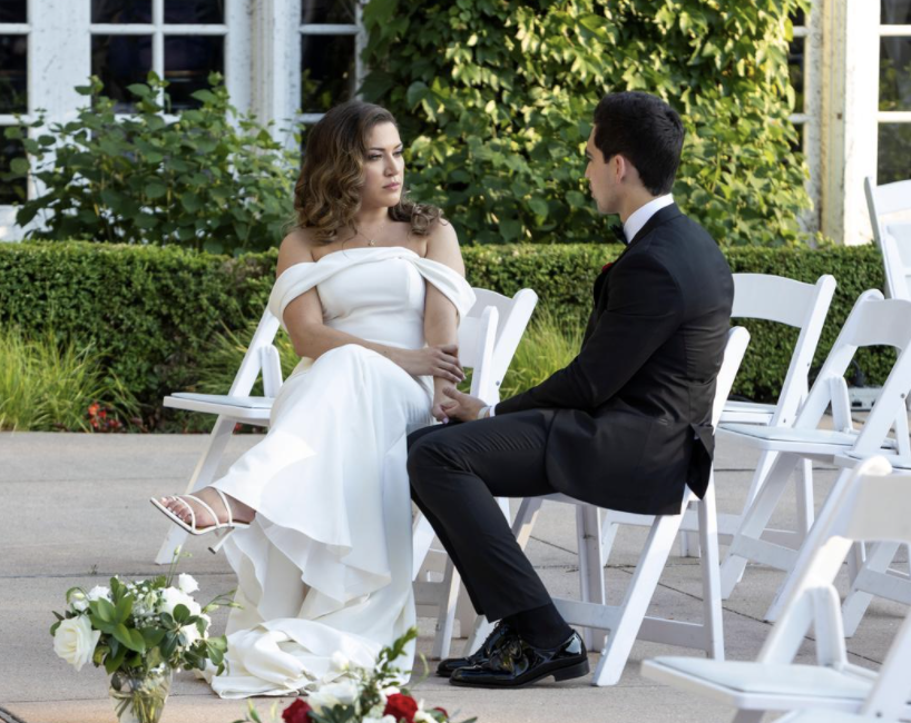 Mallory looks seriously at Sal as the two sit down in their wedding attire