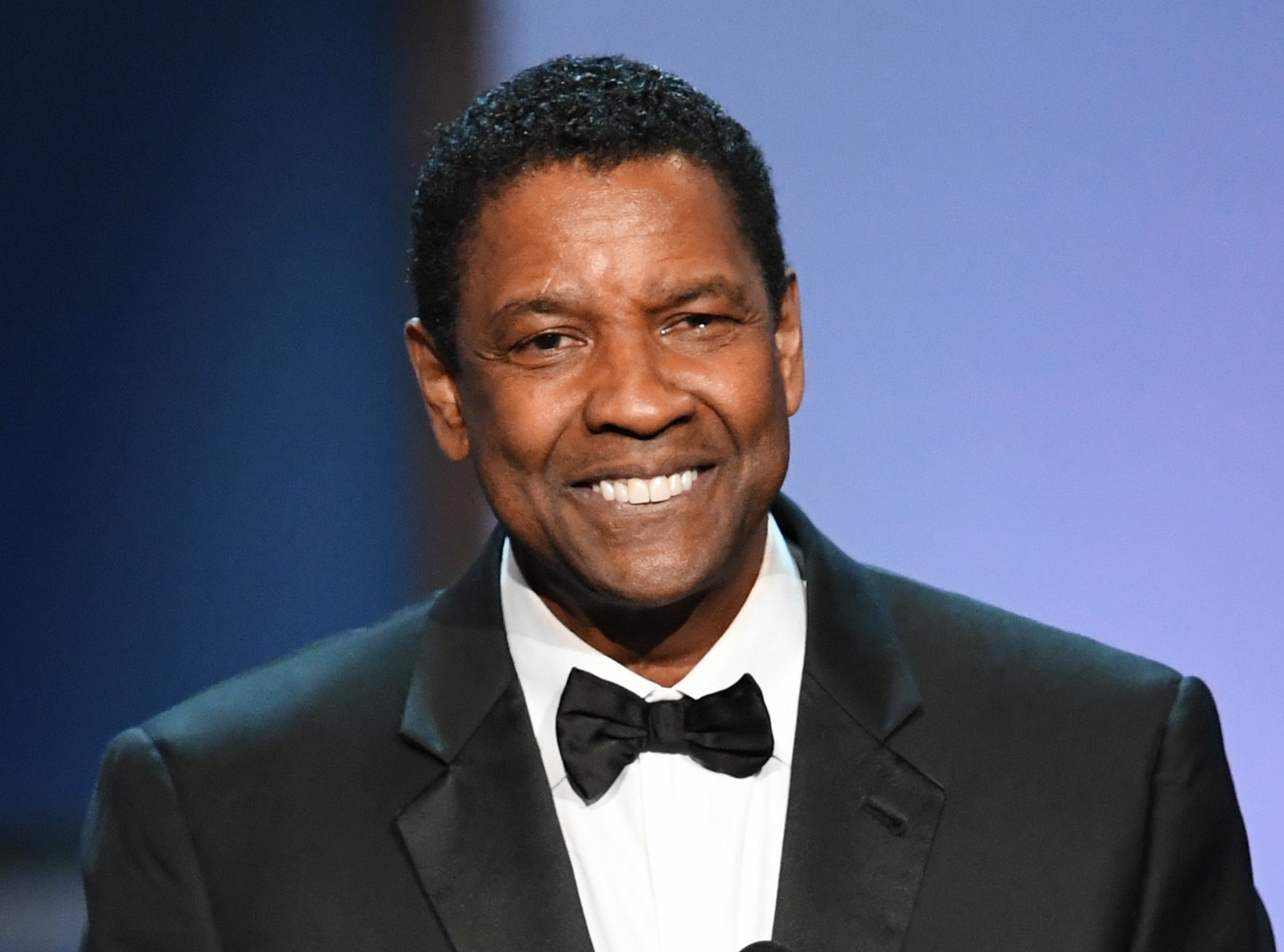 Denzel smiling in a bow tie