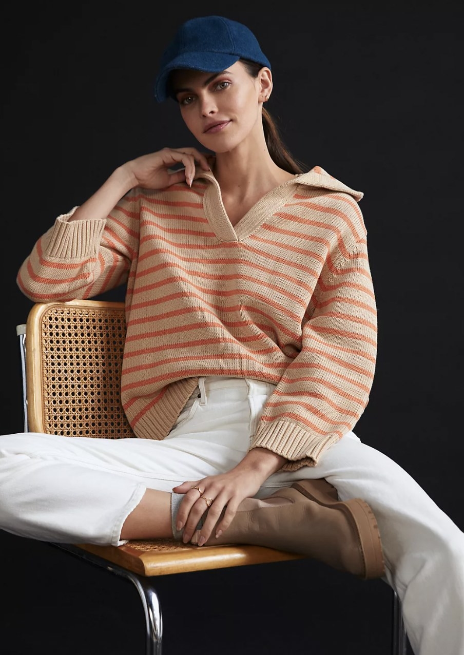 model wearing the sweater with white pants
