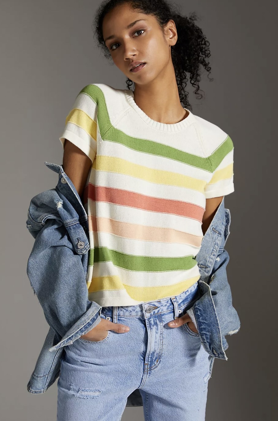 model wearing the sweater with green yellow and pink stripes