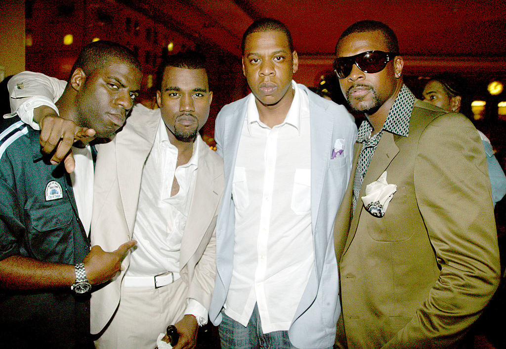 Rhymefest, Kanye West, Jay-Z, and Chris Tucker pose together for a photo at an event