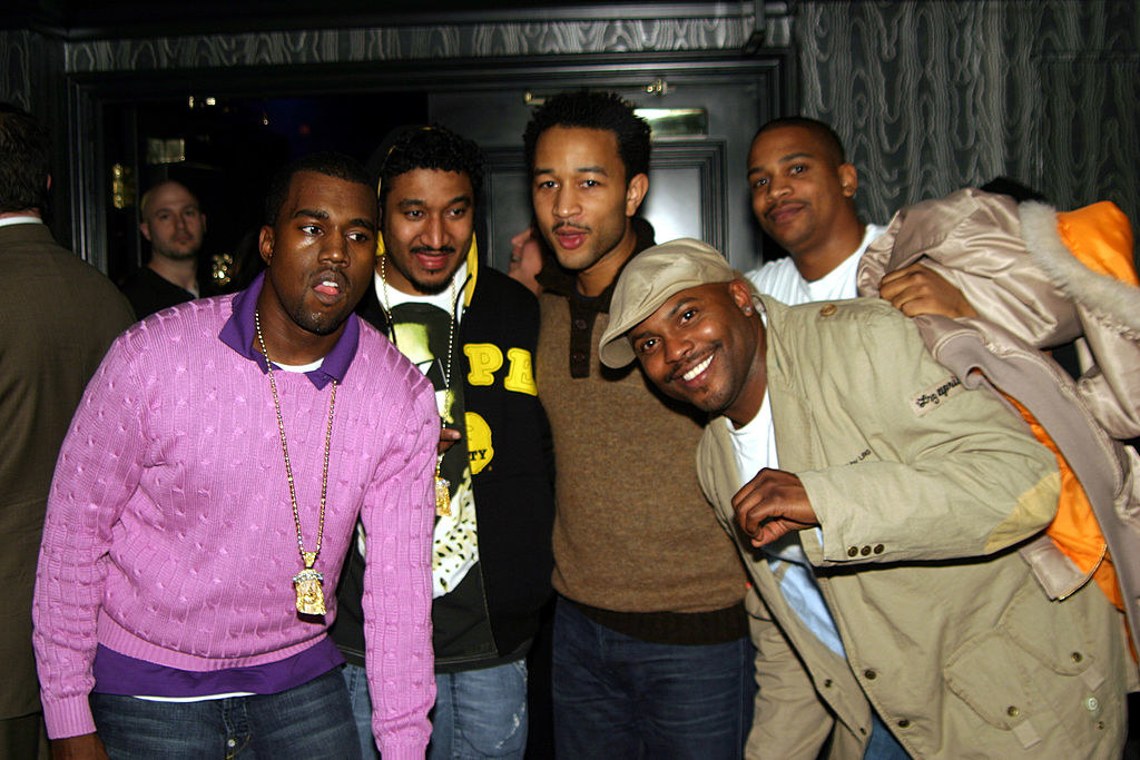 Kanye West standing with Coodie, John Legend, and others