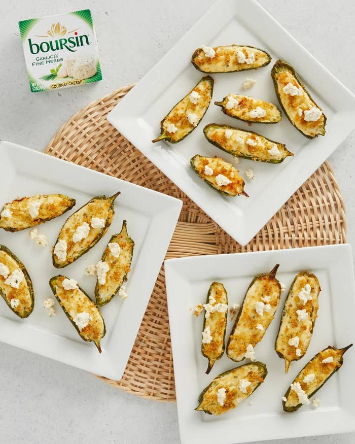 Three plates with several jalapeños sliced in half and stuffed with Boursin® Cheese and bread crumbs